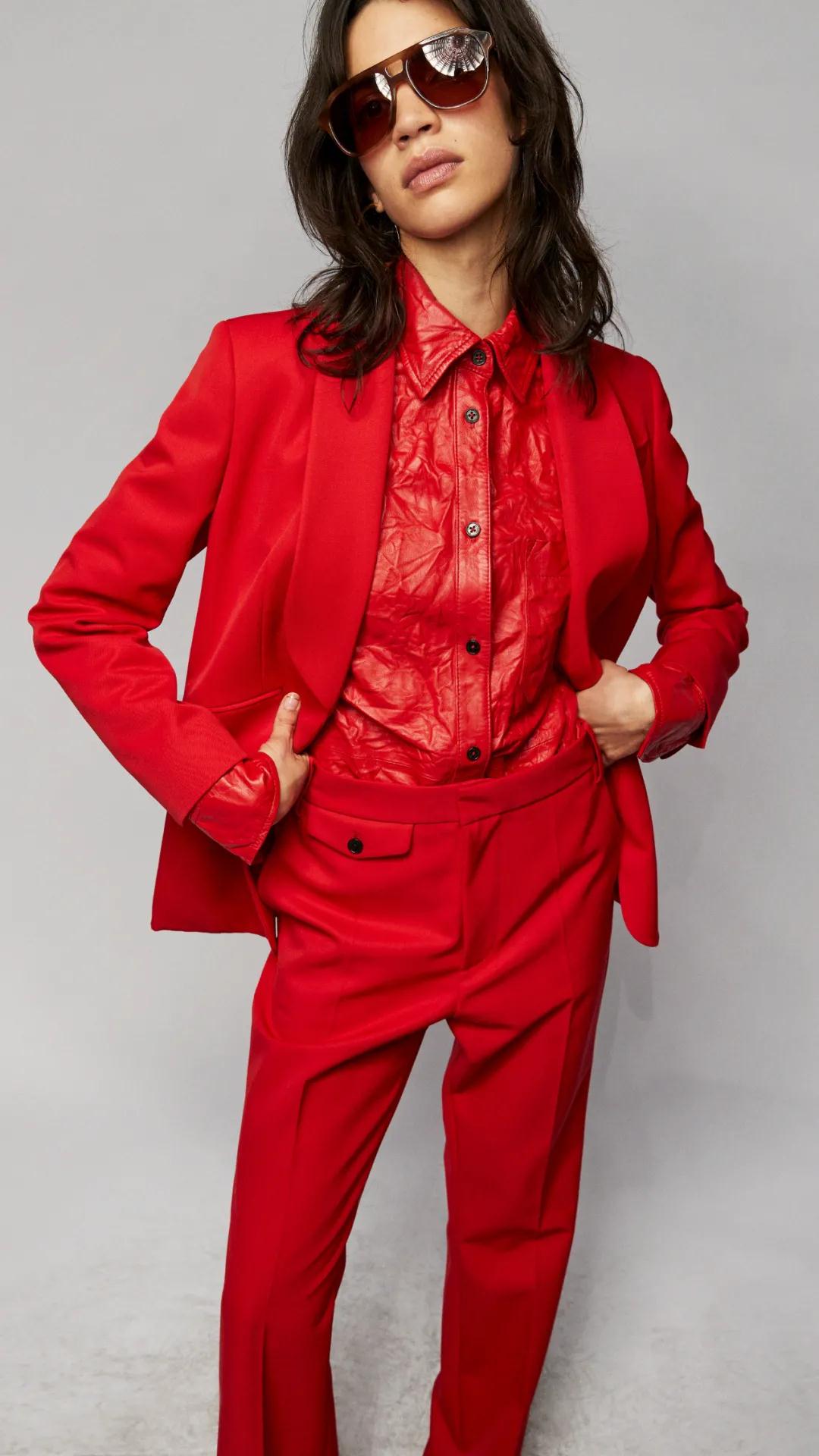 Title: A Glamorous Affair: A Female Model in Red Background Tie Suit Photoshoot