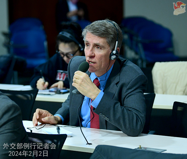 Title: State Councilor Wang Wenbin dons a sleek black tie at the recent diplomatic gathering