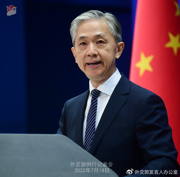 Title: State Councilor Wang Wenbin dons a sleek black tie at the recent diplomatic gathering