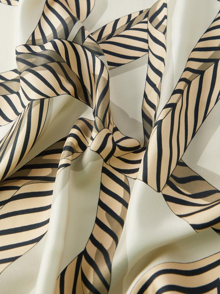 The Unique Charm of a Small Tie Knotted Silk Scarf